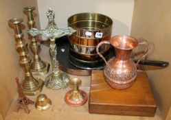 A copper and steel banded umbrella stand pair of brass candle sticks, a brass crucifix, fire tools