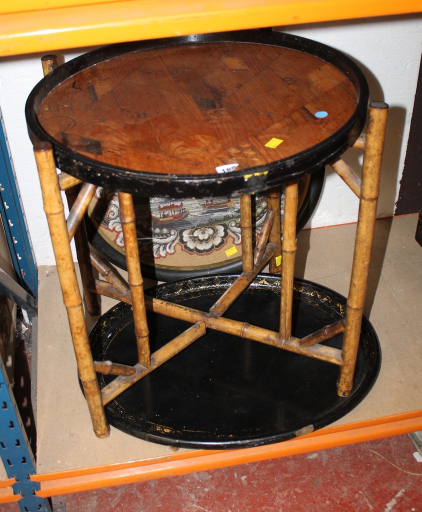 Oval beadwork banner, papier mache trayand a Japanese bamboo table. There is no condition report