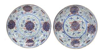 A pair of saucer dishes each of shallow, circular form decorated in underglaze blue, enamels and