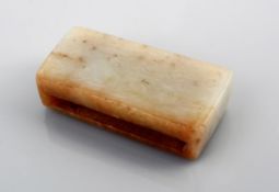 A jade sword slide of typical rectangular form, carved to one side with a design of paired ?C-