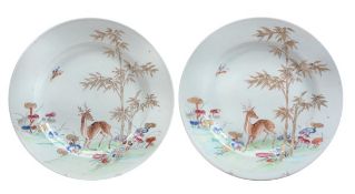 A pair of Export famille rose dishes, 19th century, each of circular form decorated in typical