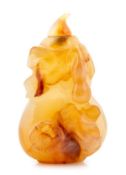 An agate snuff bottle, 19th century, finely carved with double gourds amid twisting, leafy stems,