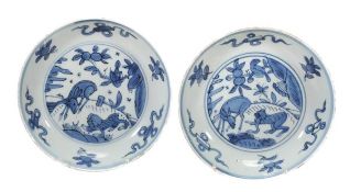 A pair of blue and white saucer dishes, Kangxi period, each of shallow, circular form decorated in