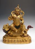 A gilt-bronze figure of Jambhala, 16th-17th century, the Wealth deity, in his White Manifestation,