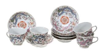 A suite of four cups and six saucers, each decorated in famille rose enamels with two five-clawed