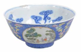 A famille rose bowl of deep circular form with slightly everted rim, decorated on a deep blue