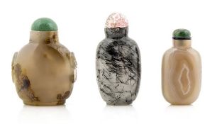 Two Chinese agate snuff bottles, of which one with banded markings and one with mask and ring