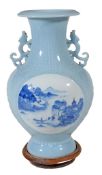 A Chinese baluster shaped vase with pierced chilong shaped handles, decorated in blue with two