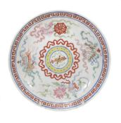 A famille rose saucer dish, 19th century, of shallow circular form decorated within a stylised