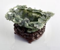 A green jade brushwasher, 19th century, carved in the form of a singler, large lotus leaf