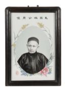 An unusual famille rose portrait plaque, early 20th century, the rectangular porcelain panel