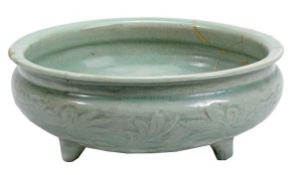 A Longquan celadon censer, Ming dynasty, of typical circular form raised on three stub feet and