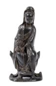 A bronze group of Guanyin and child, Ming dynasty, seated on a pierced rock throne, wearing long,