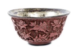 An unusual carved red lacquer bowl, Ming dynasty, with gently flaring rim and a broad foot, the