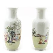 A pair of Chinese famille rose vases decorated with boys engaging in leisurely pursuits amid a