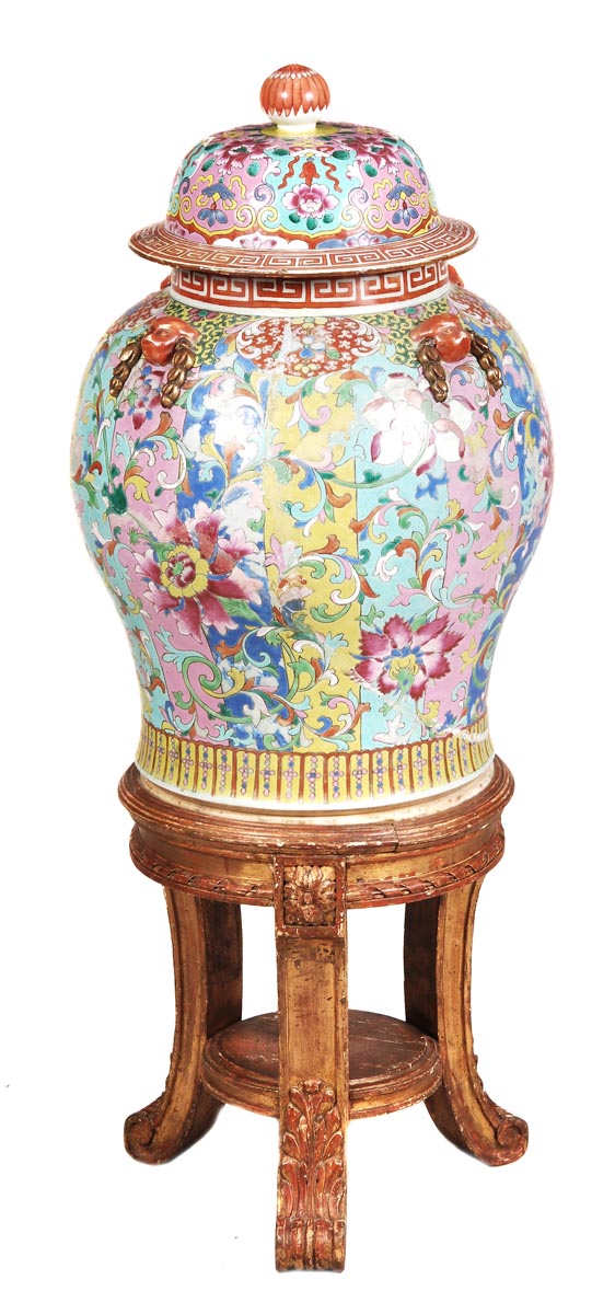 A Chinese famille rose baluster jar and cover painted with scrolling lotuses and foliage on a dark