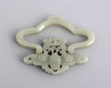 A jade hinged buckle, 19th century, of quaterfoil shape, carved from a single piece of stone the