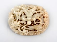 A jade mount from a ruyi sceptre, 19th century, the reticulated oval piece carved and pierced with