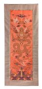 A fine coral-red silk brocade chair cover, Kangxi period (1622-1722), woven with a large full faced