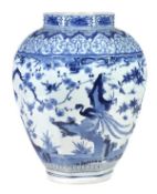 A large Arita blue and white vase of octagonal baluster form with short neck, energetically