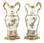 A pair of famille verte meiping vases, 17th century, of baluster shape, decorated with blooming