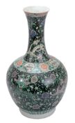 A famille noire vase, 19th century, the bulbous body resting on a short rimg foot and rising to a