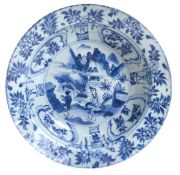 A blue and white deep bowl, Kangxi period, the circular vessel with broad edge and a crimped rim,