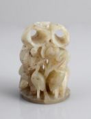 A jade finial, 19th century, of cylindrical form on a domed foot, elaborately pierced and carved