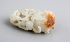 A jade pendant carved as a large double-gourd, 19th century, with further small gourds and foliage,