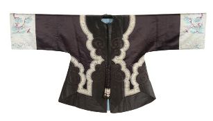 An elegant silk lady?s jacket, early 1900, the dark silk ground edged with black silk and a cream