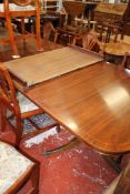 A mahogany dining table in George III style, 20th century with two extension leaves.