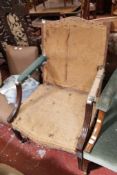 A Gainsborough style armchair in need of re-upholstery.