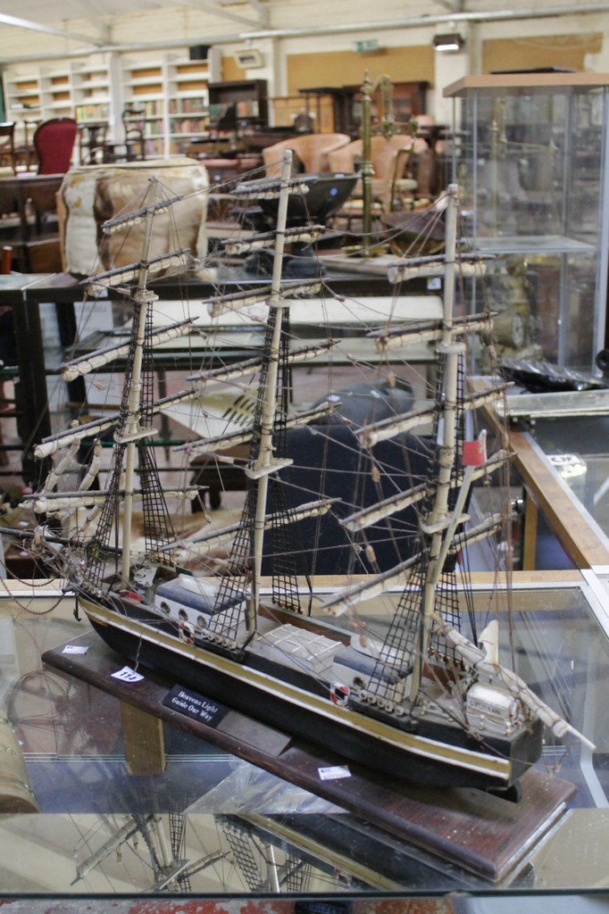A scratch built model of the Cutty Sark held in wooden base; 54cm high