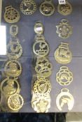 A decorative set of 16 horse brasses (8 mounted on leather strap and 8 loose) Best Bid