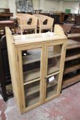 A pine glazed cabinet 130cm high, 80cm wide