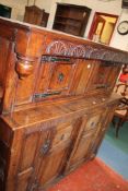 A carved oak court cupboard in Charles II style in two sections.146cm wide, 142cm high