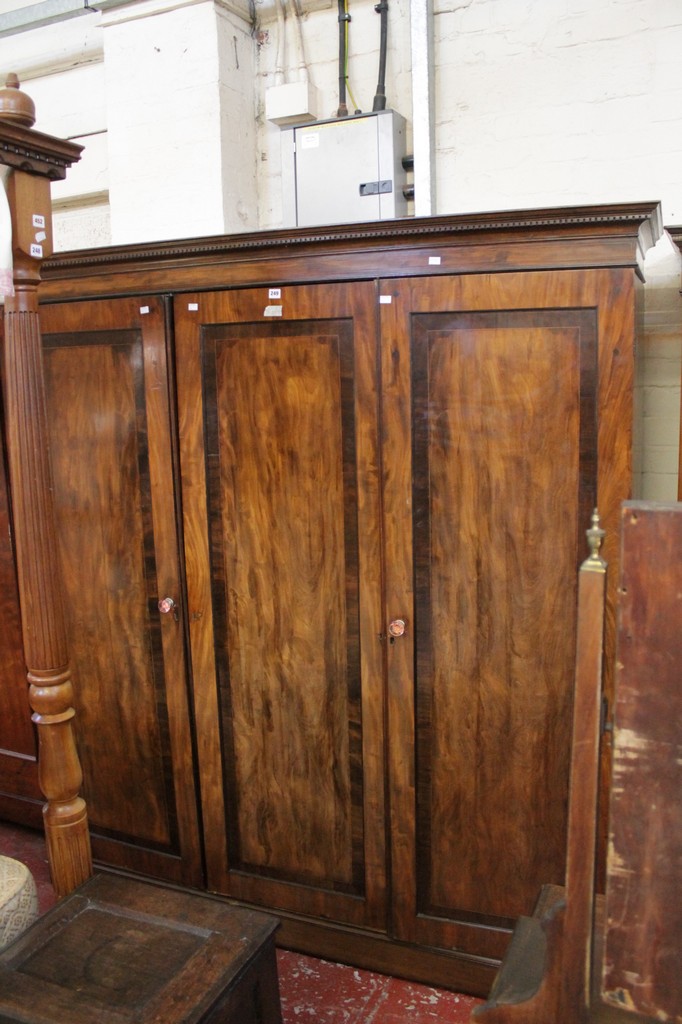 A George III style triple door mahogany wardrobe 204cm high, 180cm wide