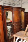An Edwardian mahogany & marquetry bowfront compactum made by Garnett of Warrington. 208cm wide.