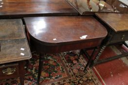 A George III mahogany and chequerbanded tea table on ring turned and tapering legs