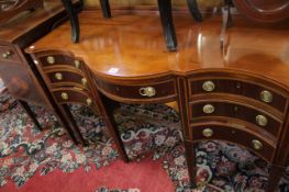 An Edwardian serpentine dressing table with three-quarter gallery top