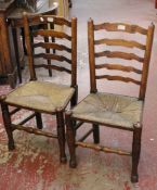 Four 18th century style oak ladderback chairs with rush seats.
