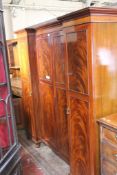 An Edwardian inverted gentleman`s mahogany compactum with central hanging space flanked by