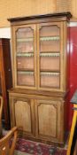 A Victorian glazed library bookcase with beaded doors below.