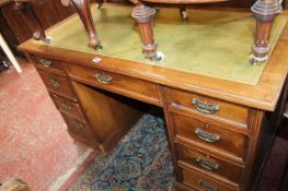 An Edwardian pedestal desk leather lined top with drawers to each pedestal.