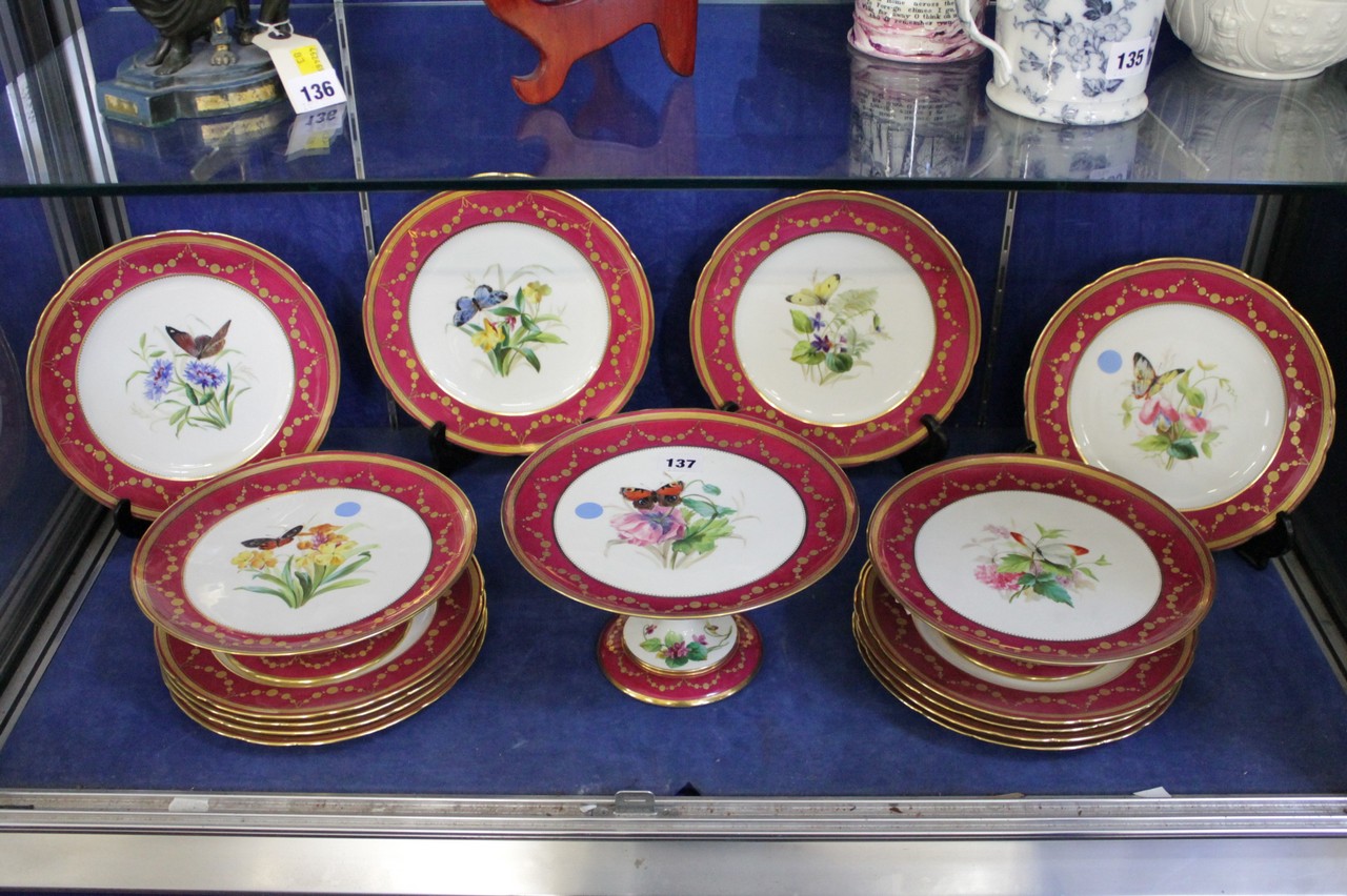 A Mintons porcelain claret ground part dessert service painted with flowers and insects