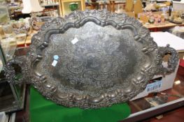 A plated oval twin handle tray, central crest; 72cm wide