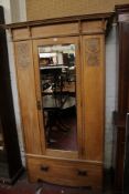 A late Victorian oak carved wardrobe with a mirrored door 204cm high, 120cm wide
