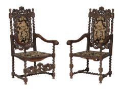A pair of carved oak chairs in Charles II style with upholstered seats