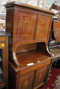 A Continental walnut cabinet on cabinet with floral marquetry to the doors.