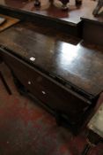 A 17th century oak oval gateleg table with a frieze drawer 97cm wide